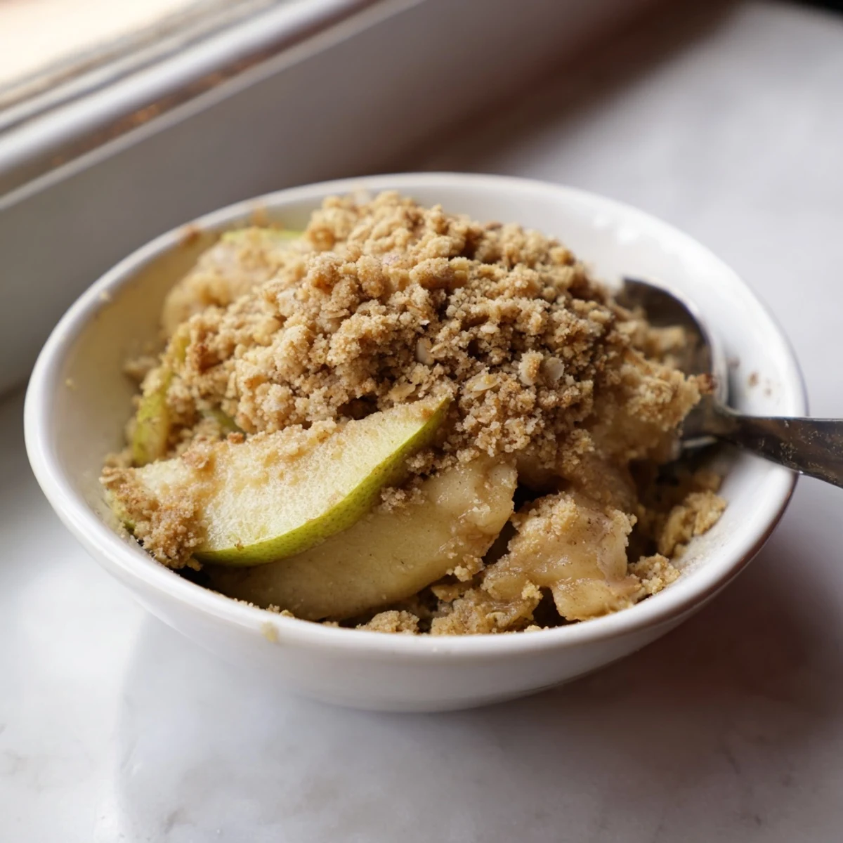 Aromatisches Apfel-Zimt-Crumble, frisch aus dem Ofen, ideal für kühle Abende.