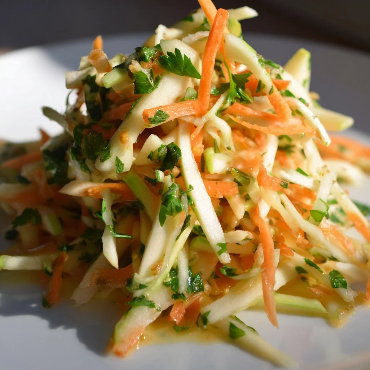 Tangy sauerkraut and apple slaw drizzled with mustard dressing, ready to enjoy.  