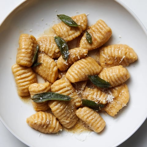 Golden-brown butternut squash gnocchi swimming in rich brown butter sauce with crispy sage.