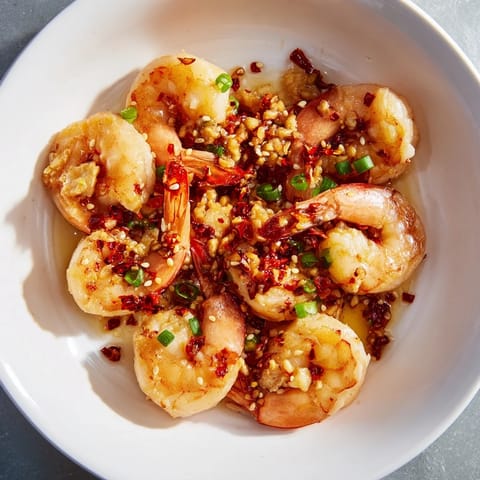 Spicy and savory Korean Garlic Butter Shrimp with sesame seeds and scallions, a delightful pescatarian meal.