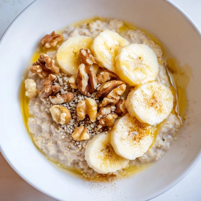 Perfectly cooked 2-minute Microwave Banana Oats with a drizzle of honey, a quick and tasty breakfast ready now.